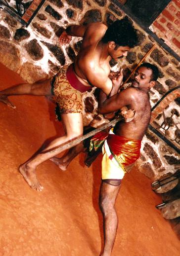 Advanced Kalaripayattu combat training showing strength and technique with practitioners demonstrating lifting and grappling moves